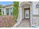 Front entry with stone accents and a white door at 13330 Blossom Valley Dr, Clermont, FL 34711