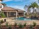 Spacious backyard featuring a luxurious pool, screened lanai, and meticulous landscaping at 15118 Pendio Dr, Bella Collina, FL 34756