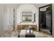 This luxury bathroom boasts a modern shower, tub with a view, and elegant stone flooring at 15118 Pendio Dr, Bella Collina, FL 34756
