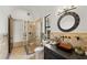 A modern bathroom featuring a glass enclosed shower, a sleek vanity, and tiled walls at 15118 Pendio Dr, Bella Collina, FL 34756