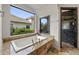 Modern bathroom with a soaking tub overlooking nature and a tiled shower at 15118 Pendio Dr, Bella Collina, FL 34756