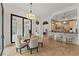 Bright dining area offering seamless indoor-outdoor living and natural light from the large glass windows at 15118 Pendio Dr, Bella Collina, FL 34756