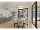 Dining area with stone floors, backyard and pool views from the dining area through large glass windows at 15118 Pendio Dr, Bella Collina, FL 34756
