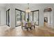 Bright dining area featuring a round table with seating and large sliding glass doors to the backyard at 15118 Pendio Dr, Bella Collina, FL 34756