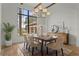 Charming dining room with large windows and a stylish chandelier creates an inviting atmosphere at 15118 Pendio Dr, Bella Collina, FL 34756