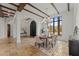 Dining room with exposed beams, stylish lighting, and seamless access to other living spaces at 15118 Pendio Dr, Bella Collina, FL 34756