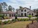 Impressive two-story house with a three-car garage and lush landscaping at 15118 Pendio Dr, Bella Collina, FL 34756