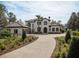 Two-story home with tile roof, driveway, and landscaping at 15118 Pendio Dr, Bella Collina, FL 34756