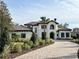 Two-story home with tile roof, three-car garage, and landscaped yard at 15118 Pendio Dr, Bella Collina, FL 34756