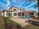 Elegant home showcasing a private pool, outdoor living space, and lush landscaping at 15118 Pendio Dr, Bella Collina, FL 34756