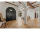 Elegant foyer featuring a massive arched front door, chandeliers, and stone floors at 15118 Pendio Dr, Bella Collina, FL 34756