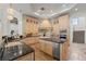 Classic eat-in kitchen with custom cabinets, granite countertops, and stainless steel appliances at 15118 Pendio Dr, Bella Collina, FL 34756