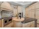 Bright kitchen featuring light cabinets, stainless steel appliances, and a large island with granite counters at 15118 Pendio Dr, Bella Collina, FL 34756