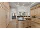 A kitchen featuring a large island with seating, and high end cabinetry and appliances at 15118 Pendio Dr, Bella Collina, FL 34756