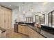An open-concept kitchen featuring modern appliances, wooden cabinets, and expansive granite countertops at 15118 Pendio Dr, Bella Collina, FL 34756