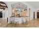 A bright kitchen with custom cabinets, a breakfast bar with seating, and stone floors, perfect for entertaining at 15118 Pendio Dr, Bella Collina, FL 34756