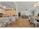 Expansive kitchen featuring custom cabinetry, bar seating, and stone floors, adjacent to living areas at 15118 Pendio Dr, Bella Collina, FL 34756