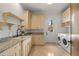 Bright laundry room offers ample storage and counter space with modern appliances at 15118 Pendio Dr, Bella Collina, FL 34756