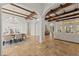 Expansive living area featuring stone flooring, arched doorways, and exposed beam ceilings at 15118 Pendio Dr, Bella Collina, FL 34756
