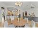 Open living area, integrating the kitchen, dining, and living spaces with neutral tones and natural lighting at 15118 Pendio Dr, Bella Collina, FL 34756