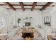 Symmetrical living room with coffered ceilings, neutral decor, and a cozy fireplace at 15118 Pendio Dr, Bella Collina, FL 34756