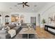 Bright living room with large sectional, modern decor, brick floors, and open floorplan at 15118 Pendio Dr, Bella Collina, FL 34756