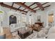 Open living room featuring coffered ceilings, neutral decor, and arched doorways at 15118 Pendio Dr, Bella Collina, FL 34756