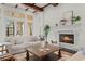 Elegant living room with travertine tile floors, a fireplace, and coffered ceilings at 15118 Pendio Dr, Bella Collina, FL 34756