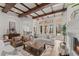 Bright living area with exposed beam ceiling, stone floors, and a beautiful fireplace at 15118 Pendio Dr, Bella Collina, FL 34756
