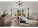 A large, bright main bedroom features a sitting area and backyard views at 15118 Pendio Dr, Bella Collina, FL 34756