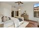A bright main bedroom features a dresser, sitting area, and ensuite bath at 15118 Pendio Dr, Bella Collina, FL 34756