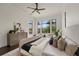 A large, bright main bedroom features a sitting area and backyard views at 15118 Pendio Dr, Bella Collina, FL 34756