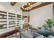 Office features a coffered ceiling with wood beams, built-in shelves, wood floors, and light neutral walls at 15118 Pendio Dr, Bella Collina, FL 34756