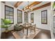 Office boasts wood beam ceiling, plantation shutters, wood floors, chandelier, and neutral color palette at 15118 Pendio Dr, Bella Collina, FL 34756