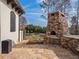 Outdoor stone oven built for entertaining; surrounded by pavers and lush landscaping at 15118 Pendio Dr, Bella Collina, FL 34756