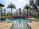 Relaxing pool area complete with a spa, fountain features, and natural surroundings at 15118 Pendio Dr, Bella Collina, FL 34756
