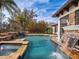 Inviting pool featuring a waterfall, spa, and serene landscaping at 15118 Pendio Dr, Bella Collina, FL 34756