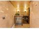 Inviting wine cellar featuring custom wine racks and a built-in cooler for elegant storage at 15118 Pendio Dr, Bella Collina, FL 34756