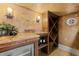 This wine cellar features textured walls and granite countertops at 15118 Pendio Dr, Bella Collina, FL 34756