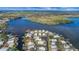 Aerial view of waterfront community with many homes and lush landscape at 16 Captains Pt, Fruitland Park, FL 34731