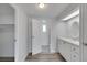 White bathroom vanity with an oval mirror at 16 Captains Pt, Fruitland Park, FL 34731