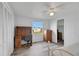 Bedroom with wood-look floors, built-in desk and dresser, and a window at 16 Captains Pt, Fruitland Park, FL 34731