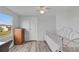 Bright bedroom with wood-look floors, dresser, and a metal daybed at 16 Captains Pt, Fruitland Park, FL 34731