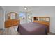 Spacious bedroom with wood furniture and window at 16 Captains Pt, Fruitland Park, FL 34731