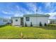 Single-wide manufactured home with a well-maintained lawn at 16 Captains Pt, Fruitland Park, FL 34731