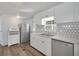 Bright kitchen with white cabinets and modern appliances at 16 Captains Pt, Fruitland Park, FL 34731