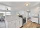 Open kitchen with white cabinets and stainless steel appliances at 16 Captains Pt, Fruitland Park, FL 34731