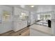 White kitchen with stainless steel appliances and a breakfast bar at 16 Captains Pt, Fruitland Park, FL 34731