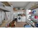 Laundry room with washer, dryer, and ample storage shelving at 16 Captains Pt, Fruitland Park, FL 34731