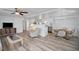 Open living area with hardwood floors and views into the kitchen and dining area at 16 Captains Pt, Fruitland Park, FL 34731